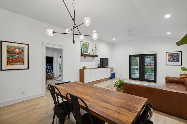 dining room with french doors, light hardwood / wood-style floors, vaulted ceiling, and ceiling fan