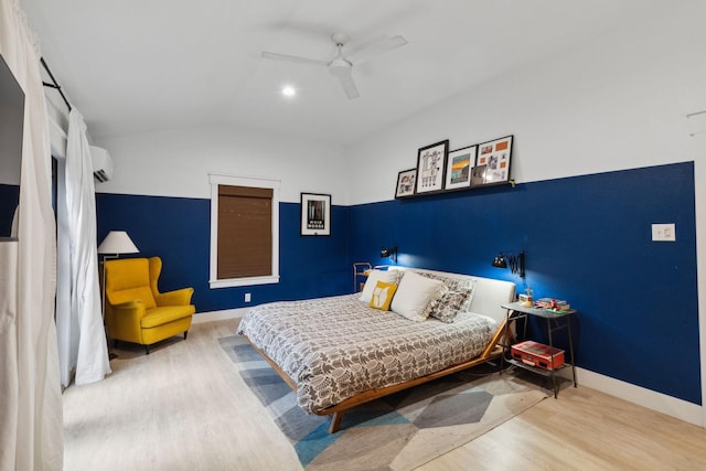 bedroom featuring hardwood / wood-style flooring, ceiling fan, and a wall unit AC