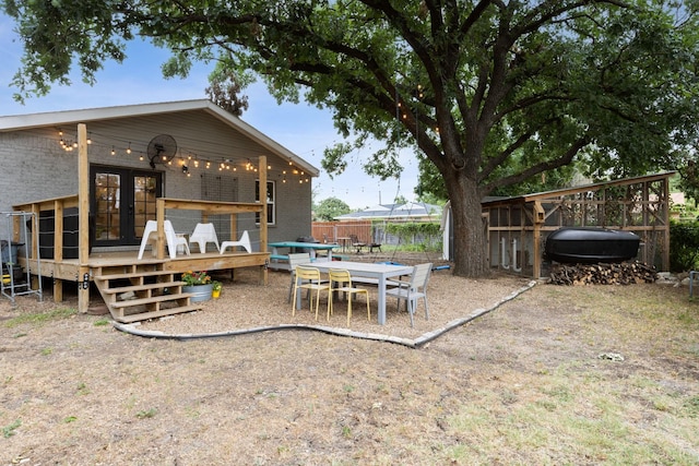 exterior space featuring a deck and french doors