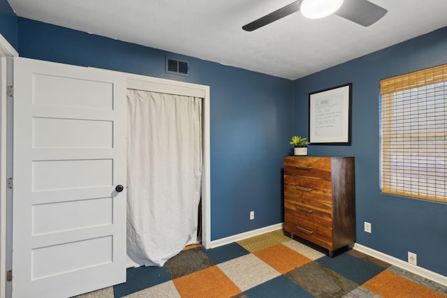 bedroom featuring ceiling fan and dark carpet