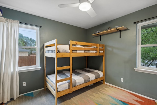 bedroom featuring multiple windows and ceiling fan