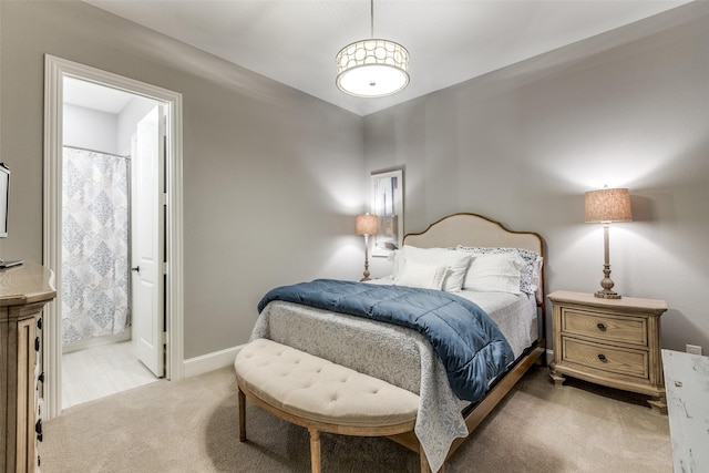 carpeted bedroom featuring connected bathroom