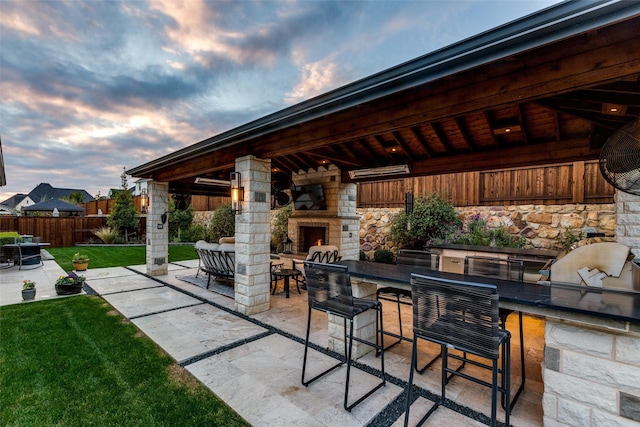 view of patio / terrace with a gazebo, area for grilling, and exterior fireplace