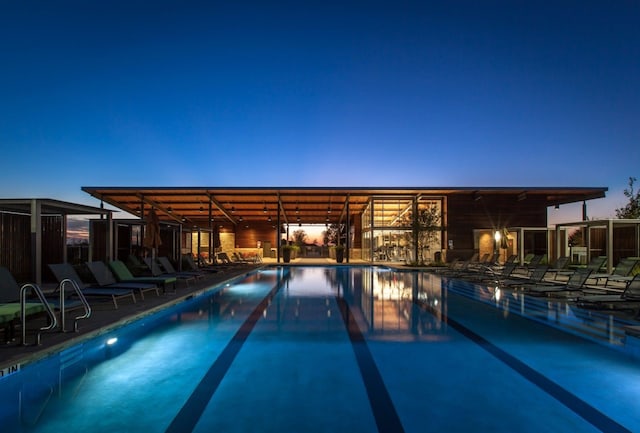 view of pool at dusk