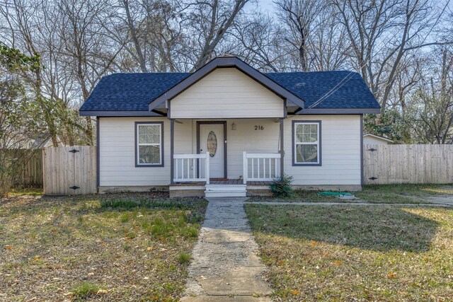 bungalow-style house featuring a front yard and covered porch