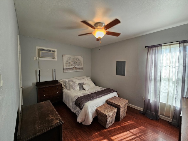 bedroom with a wall mounted AC, ceiling fan, electric panel, and dark wood-type flooring