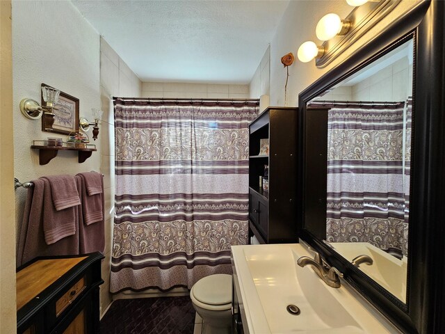 bathroom featuring vanity, a textured ceiling, tile patterned flooring, toilet, and curtained shower