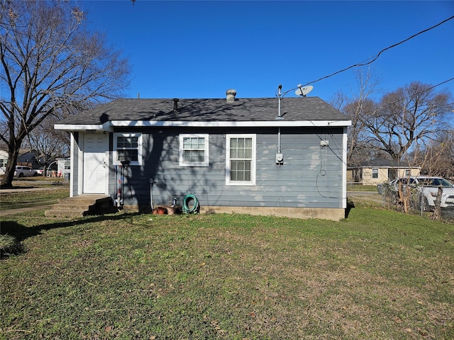 rear view of house with a lawn