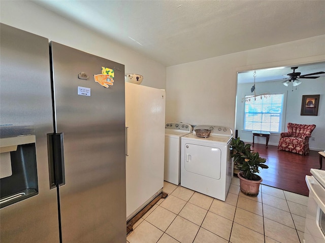 laundry room with ceiling fan, separate washer and dryer, and light tile patterned floors