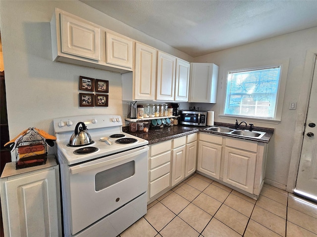 kitchen featuring light tile patterned flooring, white electric range, and sink