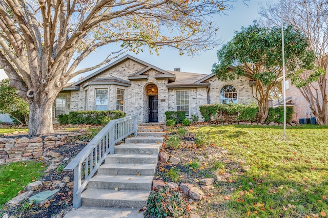 ranch-style home featuring a front lawn