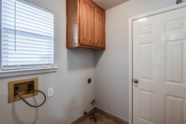 clothes washing area featuring cabinets, hookup for a washing machine, and hookup for an electric dryer