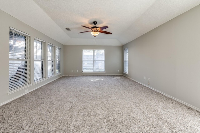 carpeted spare room featuring a textured ceiling, ceiling fan, and lofted ceiling