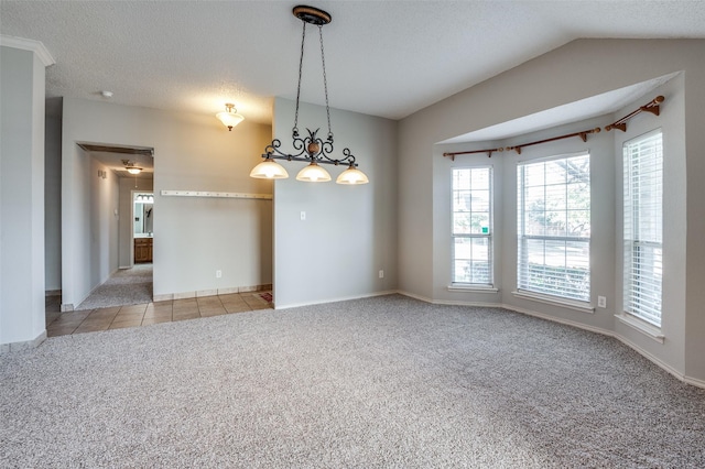 spare room with lofted ceiling, light colored carpet, and a textured ceiling