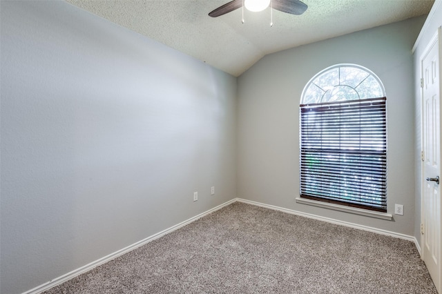 carpeted empty room featuring ceiling fan, a textured ceiling, and vaulted ceiling