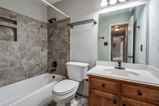 full bathroom featuring vanity, toilet, and tiled shower / bath combo