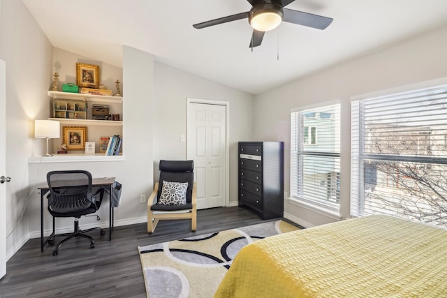 bedroom with ceiling fan, dark wood-type flooring, and vaulted ceiling