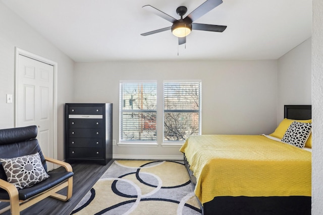 bedroom with ceiling fan and dark hardwood / wood-style flooring