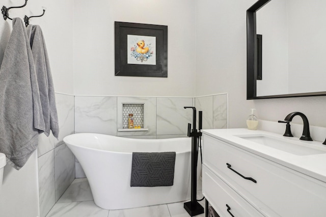 bathroom featuring tile walls, vanity, and a bathing tub