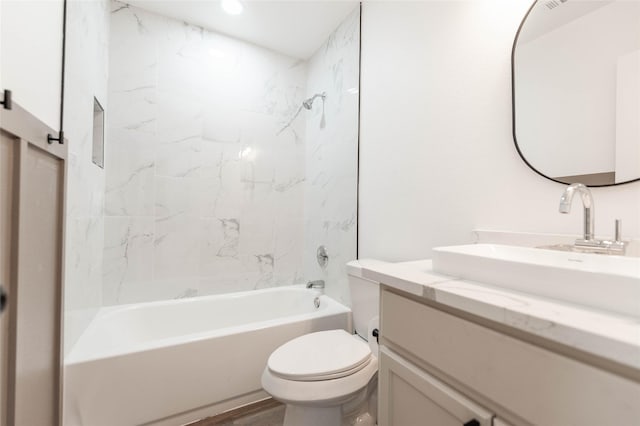 full bathroom with tiled shower / bath, hardwood / wood-style floors, vanity, and toilet