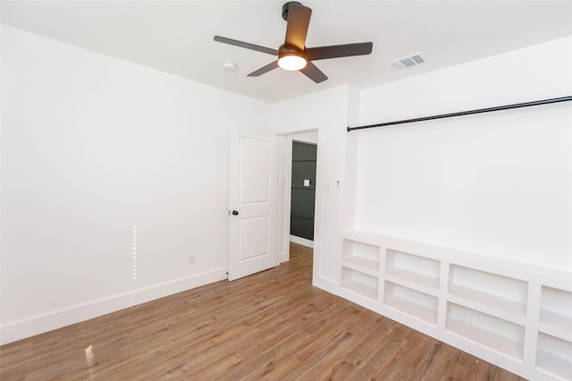 spare room with hardwood / wood-style floors and ceiling fan