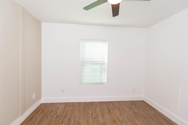 empty room with hardwood / wood-style flooring and ceiling fan