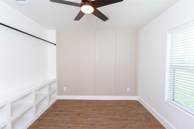 spare room with plenty of natural light, dark wood-type flooring, and ceiling fan