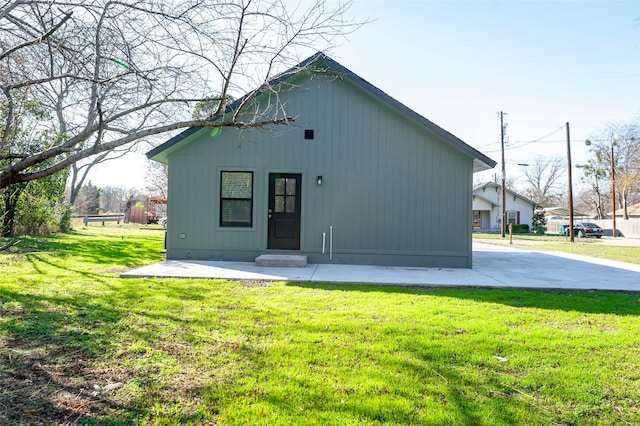 back of property featuring a lawn