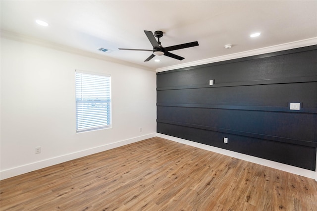 unfurnished room featuring ceiling fan, light hardwood / wood-style floors, and ornamental molding