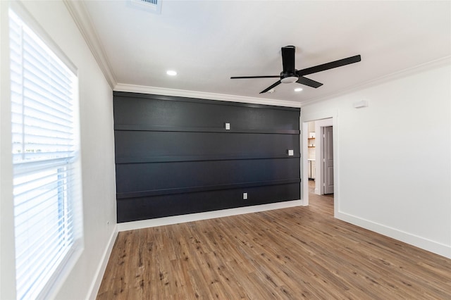 unfurnished room with hardwood / wood-style flooring, ceiling fan, and crown molding