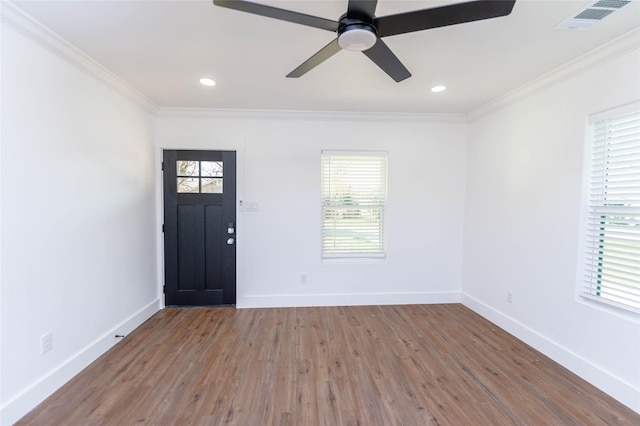 spare room with hardwood / wood-style floors, ornamental molding, and a healthy amount of sunlight