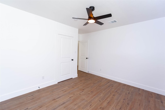 empty room featuring ceiling fan and wood-type flooring