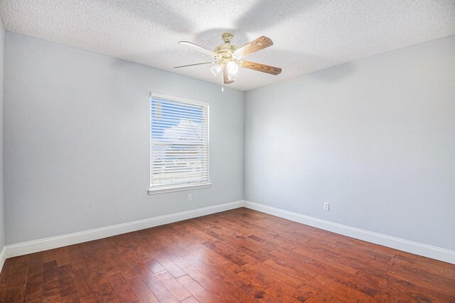 spare room featuring a textured ceiling, dark hardwood / wood-style floors, and ceiling fan