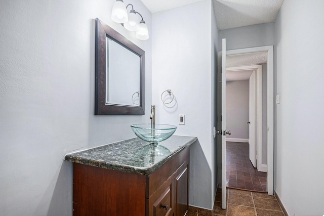 bathroom featuring vanity and a textured ceiling