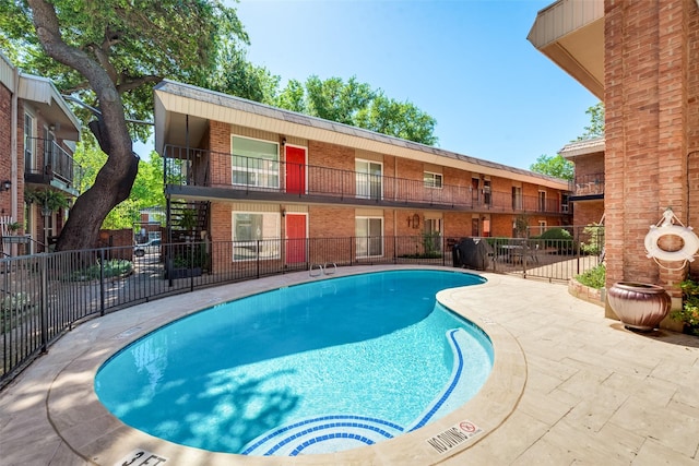 view of swimming pool with a patio area