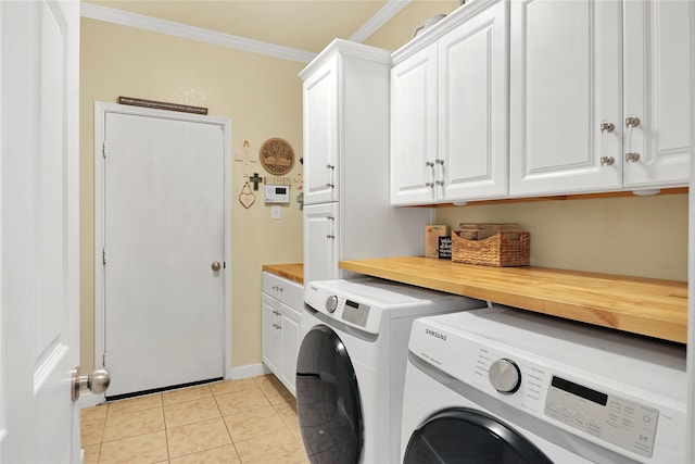 laundry room with ornamental molding, light tile patterned flooring, cabinets, and independent washer and dryer