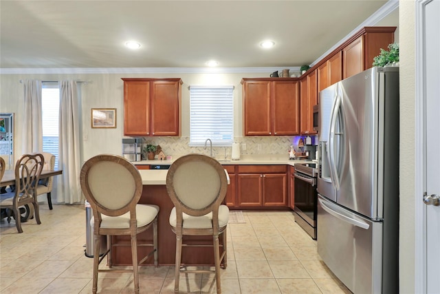 kitchen with a wealth of natural light, crown molding, and appliances with stainless steel finishes