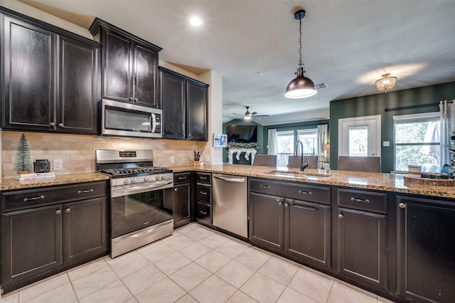 kitchen with plenty of natural light, ceiling fan, sink, and stainless steel appliances