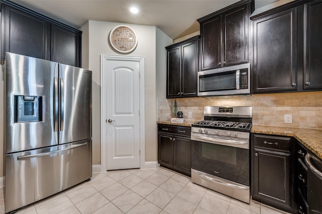 kitchen featuring light stone countertops, light tile patterned floors, stainless steel appliances, and tasteful backsplash