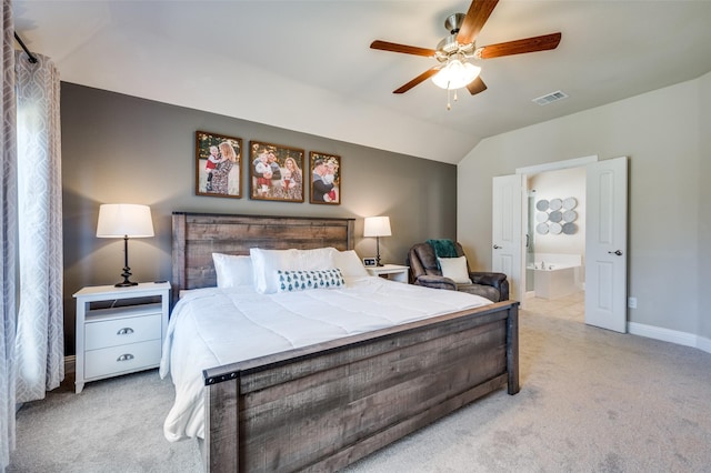 bedroom featuring light carpet, ensuite bath, ceiling fan, and lofted ceiling