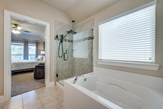 bathroom featuring tile patterned flooring, independent shower and bath, lofted ceiling, and a wealth of natural light