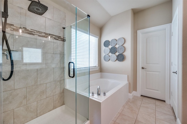 bathroom featuring vaulted ceiling, tile patterned floors, and independent shower and bath