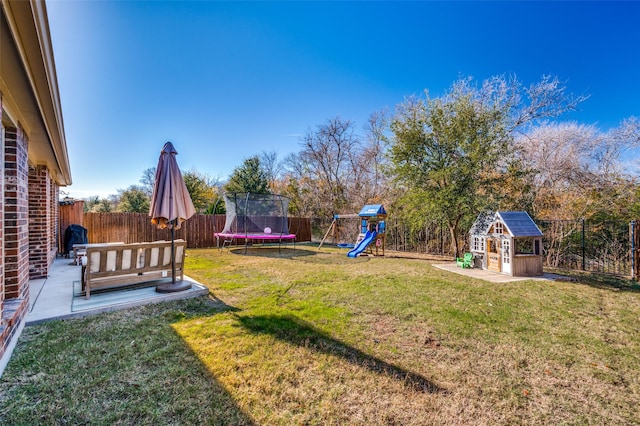 view of yard featuring a playground, a trampoline, and an outdoor structure