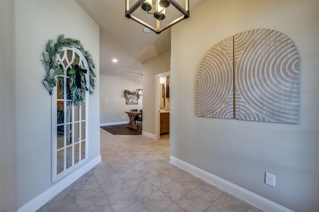 hallway with an inviting chandelier