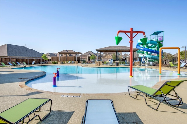 view of swimming pool featuring a patio area and a water slide