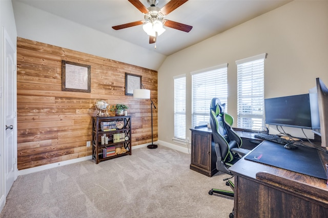 office featuring light carpet, ceiling fan, lofted ceiling, and wood walls