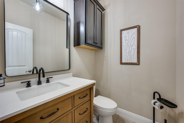 bathroom with tile patterned flooring, vanity, and toilet