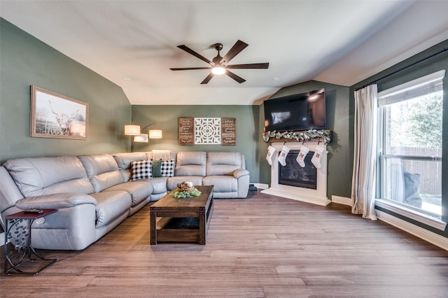 living room featuring hardwood / wood-style flooring, ceiling fan, and lofted ceiling