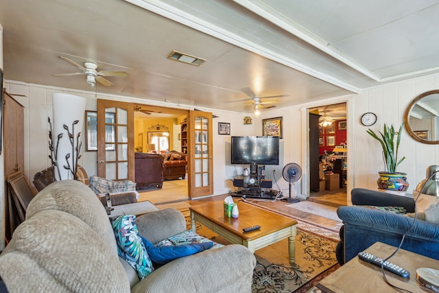 living room featuring french doors and light hardwood / wood-style flooring