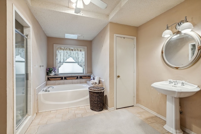 bathroom with plus walk in shower, a textured ceiling, and tile patterned floors